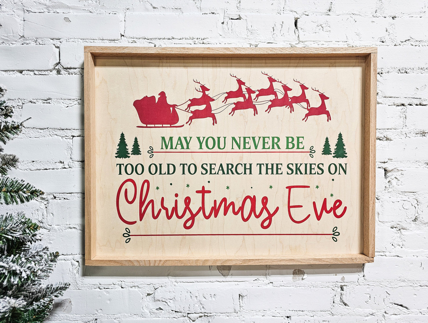 may you never be too old to search the skies on christmas eve holiday wooden sign wall decor hanging with santa claus in sleigh and reindeer at top of sign