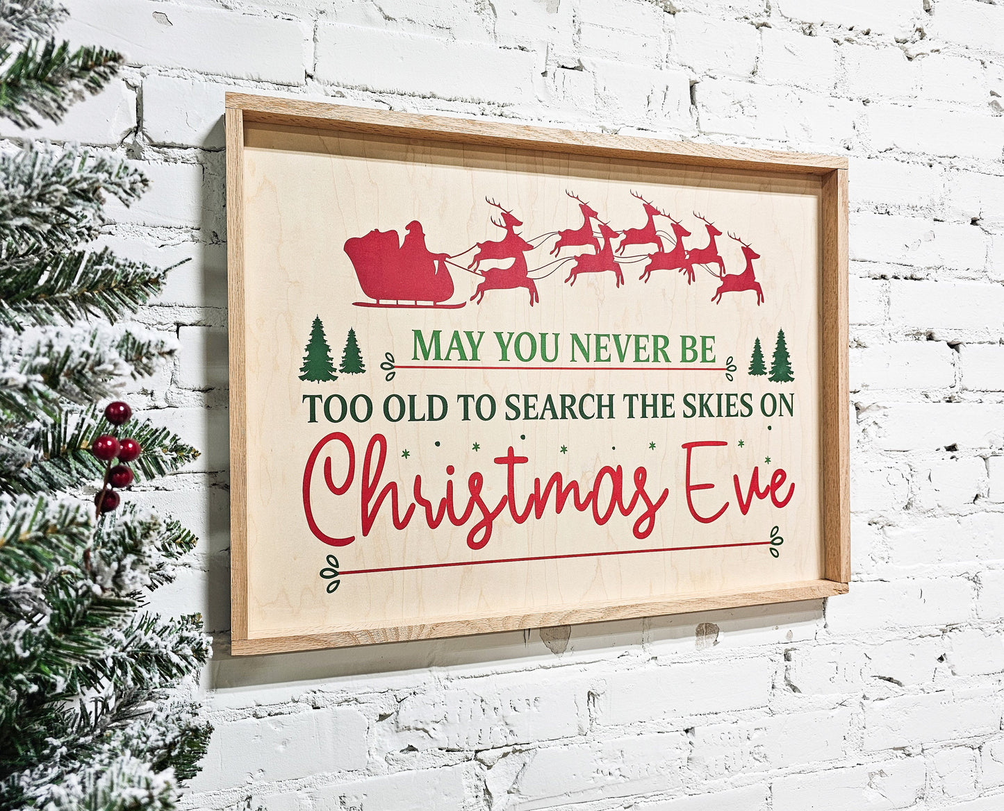 may you never be too old to search the skies on christmas eve holiday wooden sign wall decor hanging with santa claus in sleigh and reindeer at top of sign