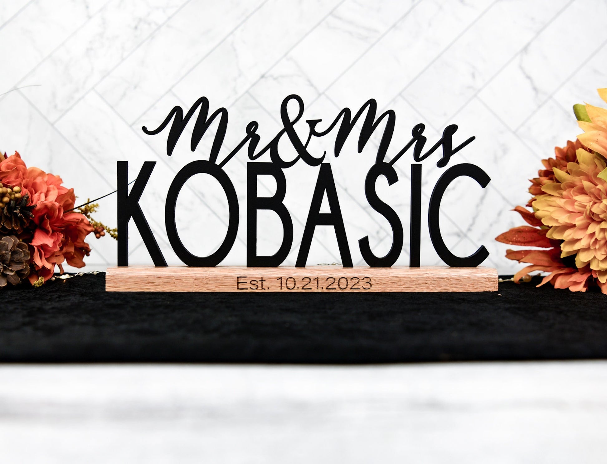 custom wedding sign table decor personalized with mr and mrs plus family last name, date engraved on oak wood base that holds the name sign upright for stand alone ability.