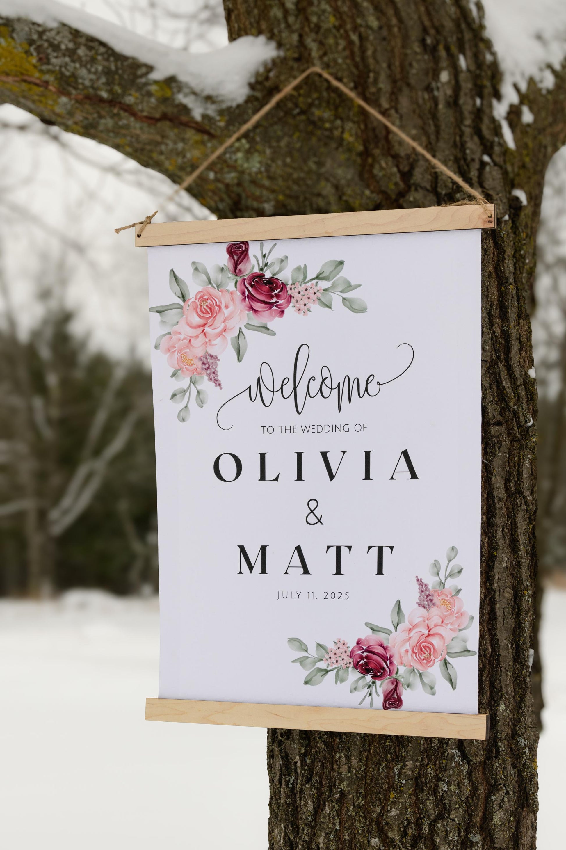 custom welcome to our wedding sign, ceremony entrance, reception entrance wedding decor, personalized with welcome message, couples names and date of venue, accented with floral designs in the corners, sign has wood top & bottom, it is made from canvas, it hangs freely with a rope on top.