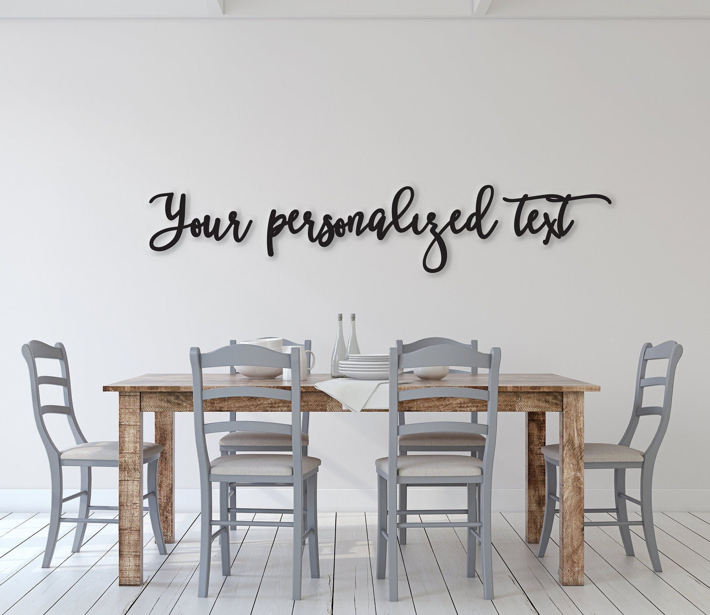 May include: A wooden dining table with four gray chairs. The table has a light brown wood finish and the chairs have a light gray finish. The wall behind the table is white and has black cursive text that reads 'Your personalized text'.