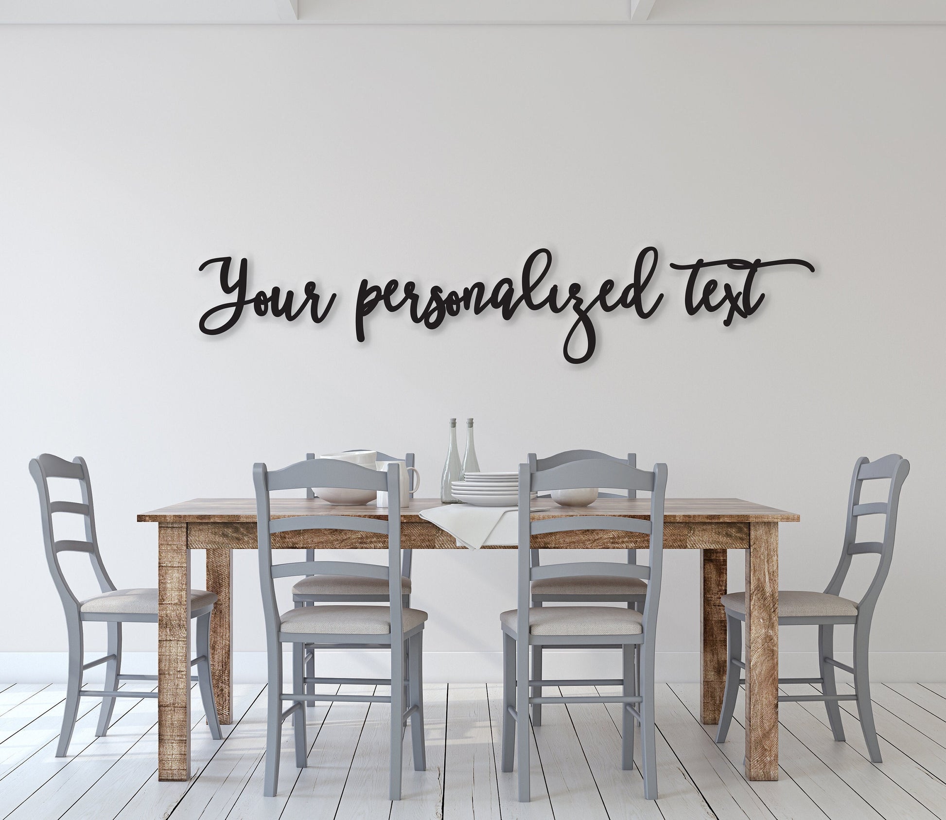 May include: A wooden dining table with four gray chairs. The table has a light brown wood finish and the chairs have a light gray finish. The wall behind the table is white and has black cursive text that reads 'Your personalized text'.
