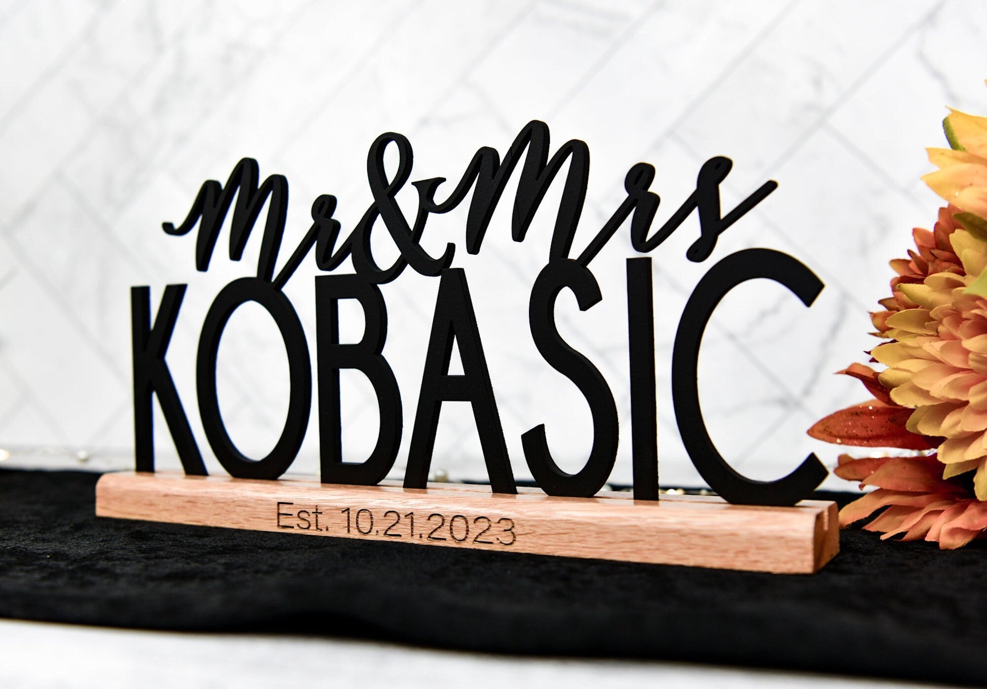 custom wedding sign table decor personalized with mr and mrs plus family last name, date engraved on oak wood base that holds the name sign upright for stand alone ability.