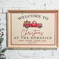personalized christmas welcome sign with family last name and first names with est year. featuring a vintage little red christmas truck. design is printed on natural wood & framed with natural wood for a boho / farmhouse sign look
