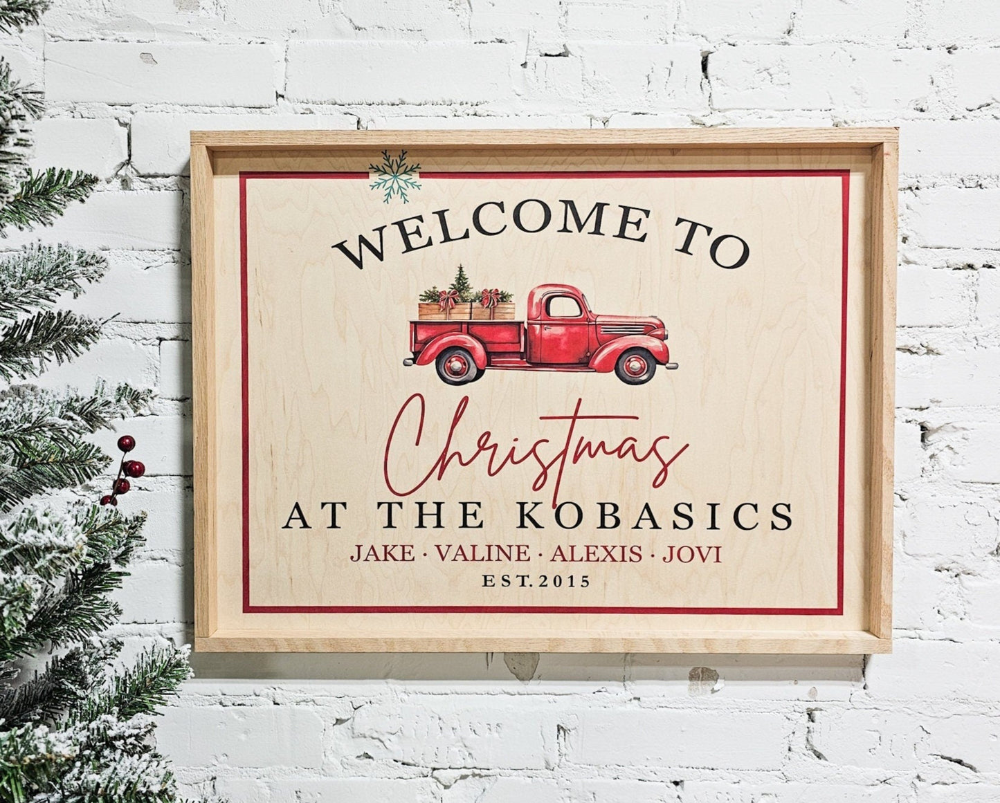 personalized christmas welcome sign with family last name and first names with est year. featuring a vintage little red christmas truck. design is printed on natural wood & framed with natural wood for a boho / farmhouse sign look