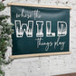 Where the wild things play, playroom hanging wall art sign, pine green background & white lettering canvas, framed top and bottom, hangs by rope, woodland letters