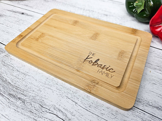 personalized cutting board, wood is bamboo, it is engraved with couple&#39;s first name & heart in the middle with est year below. prefect custom christmas gift, anniversary or wedding gift. mothers day or fathers day gift