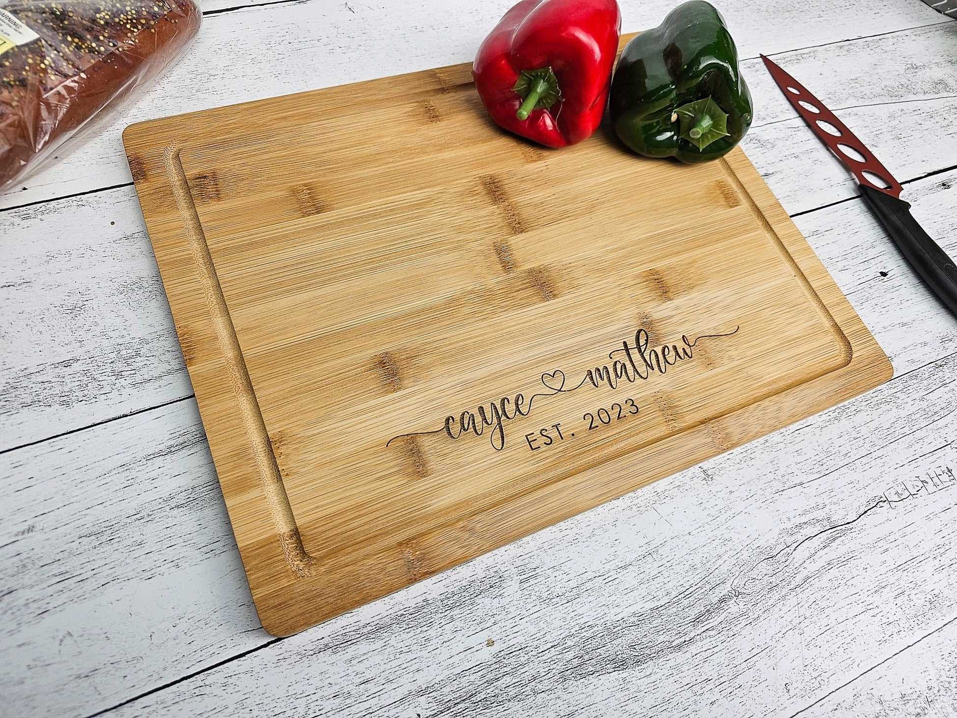 personalized cutting board, wood is bamboo, it is engraved with couple&#39;s first name & heart in the middle with est year below. prefect custom christmas gift, anniversary or wedding gift. mothers day or fathers day gift